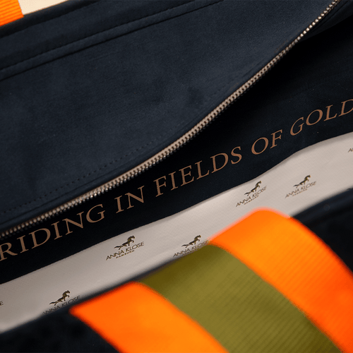 Close up of the lining of a dark blue horse riding equipment bag with a personalized inscription