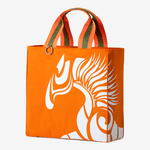 Horse riding equipment bag made of orange vegan leather with white logo and Anna Klose lettering
