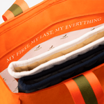 Close up of the lining of an orange horse riding equipment bag with a personalized inscription