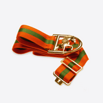 Close up of Anna Klose belt in orange-green-orange colors with gold logo buckle