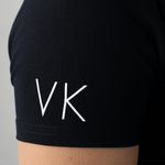 Close-up of initials personalized in white on a black polo shirt sleeve from Anna Klose Hamburg
