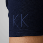 Close-up of initials personalized in blue on a dark blue polo shirt sleeve from Anna Klose Hamburg